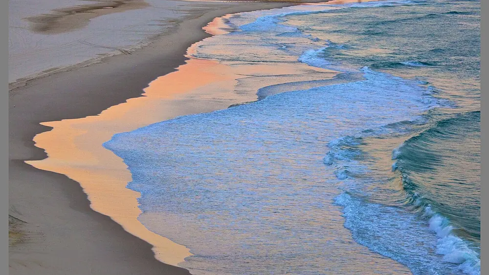Wet sand and shallow surf at sunrise on Tugun Beach